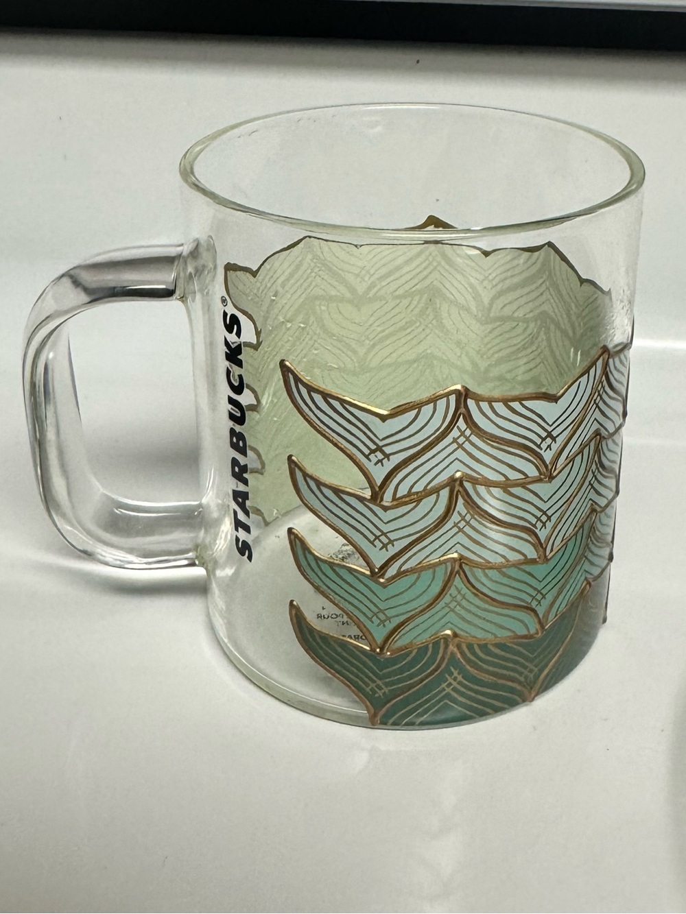 Starbucks Clear Glass Mug with Green and Teal Leaf Design and Gold Accents
